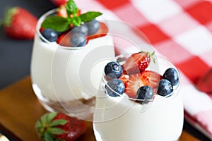 Healthy Breakfast Concept. Muesli with Greek Yogurt, Strawberries and Blueberries, Diet, Summer Food. Black Background, Close-up,