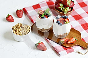 Healthy Breakfast Concept. Muesli with Greek Yogurt, Strawberries and Blueberries