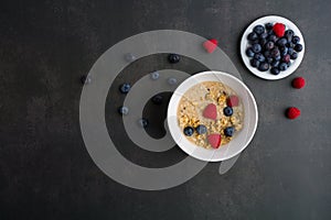 Healthy breakfast concept with oat flakes and fresh berries on rustic background. muesli. strawberries, blueberries