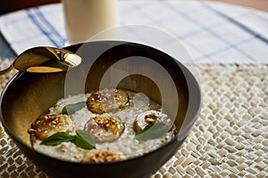 Healthy breakfast concept with oatmeal bowl and milk glass