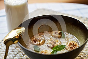 Healthy breakfast concept with oatmeal bowl and milk glass