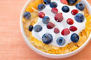 Healthy breakfast  - Cornflakes with bilberries, raspberries and yogurt