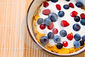 Healthy breakfast  - Cornflakes with bilberries, raspberries and yogurt