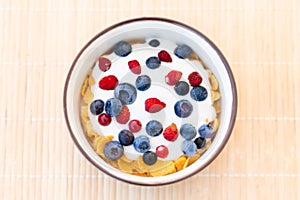 Healthy breakfast  - Cornflakes with bilberries, raspberries and yogurt
