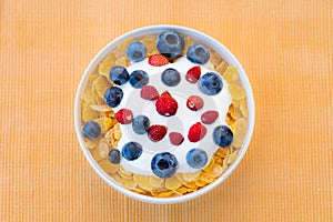 Healthy breakfast  - Cornflakes with bilberries, raspberries and yogurt