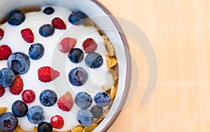 Healthy breakfast  - Cornflakes with bilberries, raspberries and yogurt