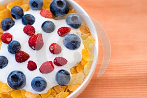 Healthy breakfast  - Cornflakes with bilberries, raspberries and yogurt