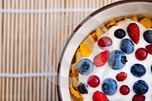 Healthy breakfast  - Cornflakes with bilberries, raspberries and yogurt