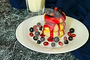 Healthy breakfast - cottage cheese pancakes, cheesecakes, cottage cheese pancakes with jam and fresh berries.