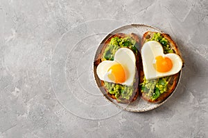 Healthy breakfast with eggs hearts and cup of coffee on grey background