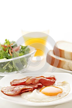 Healthy breakfast with a focus on bacon eggs,