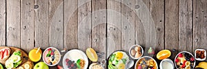 Healthy breakfast food banner with table scene bottom border of fruit, yogurt, smoothie bowl, nutritious toasts, cereal and egg sk