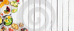 Healthy breakfast food banner with table scene side border of fruit, yogurt, smoothie, nutritious toasts and egg skillet over a wh