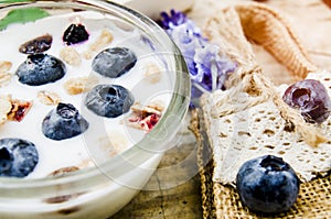 Healthy breakfast with Fresh yogurt, granola and muesli with  cherry and berries in small glass on Wooden tray, Food concept for