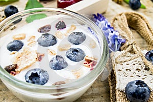 Healthy breakfast with Fresh yogurt, granola and muesli with  cherry and berries in small glass on Wooden tray, Food concept for