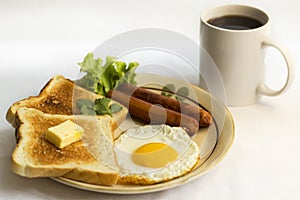 Healthy breakfast fried egg yellow yolk, toast bread, sausage, vegetable in morning