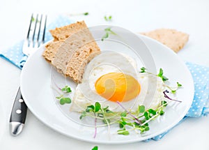 Healthy breakfast. Fried heart shaped egg