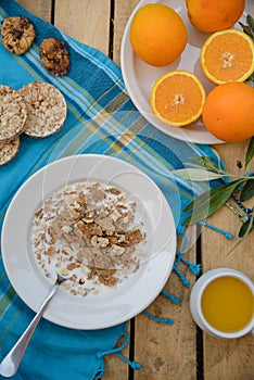 Healthy breakfast, fruit, corn flakes, milk and orange juice on the wooden table