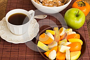 Healthy breakfast with fruit salad, granola and coffee.