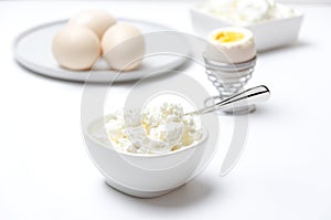 Healthy breakfast full of protein and calcium.Cottage cheese, eggs.White and bright colors