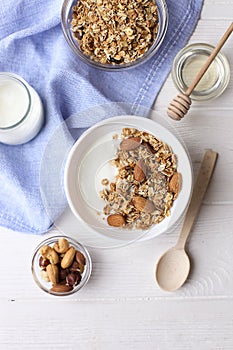 Healthy breakfast granola with nuts on window sill at home