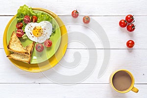 Healthy Breakfast with heart-shaped fried egg, toast, cherry tom
