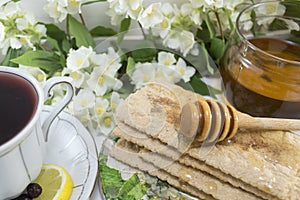 Healthy breakfast with honey and chokeberry tea