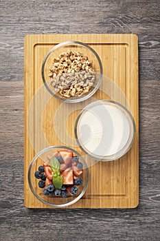 Healthy breakfast ingredients - puffed wheat with milk and fruits, strawberries, blueberries,