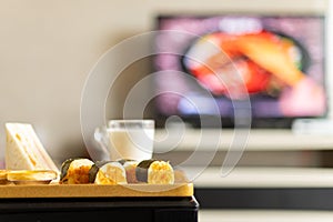 healthy breakfast in living room with a TV broadcasting a food making programme