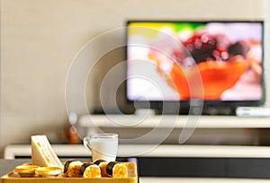 a healthy breakfast in a living room with a TV broadcasting a food programme photo