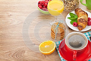 Healthy breakfast with muesli, berries, orange juice, coffee and