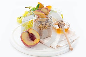 Healthy breakfast: muesli with smoothie, honey, yogurt and fresh berries in a glass jar