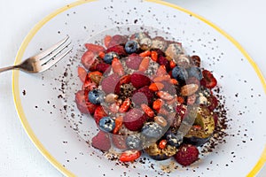 Healthy breakfast of oat grains porridge with fresh berries and nuts