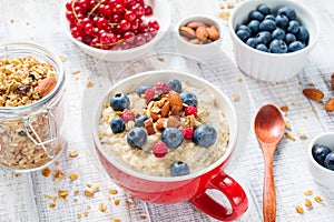 Healthy breakfast, oatmeal porridge with berries and nuts