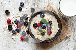 Healthy breakfast. oatmeal porridge in a bowl with glass of milk