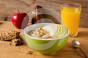 Healthy breakfast, oatmeal porridge with fruits, nuts and juice