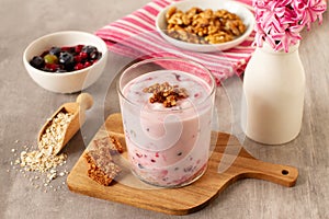 Healthy breakfast with oatmeal, yogurt, nuts and red fruits