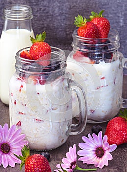 Healthy breakfast overnight oats with fresh berry in mason jar photo