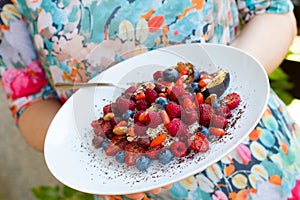 Healthy breakfast a plate with lowering cholesterol food- oatmeal porridge with fresh berries and nuts