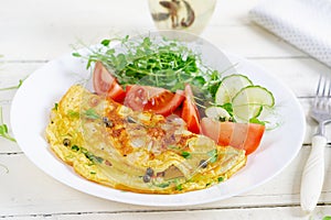 Healthy breakfast.Quesadilla with omelette, bacon and tomatoes salad.