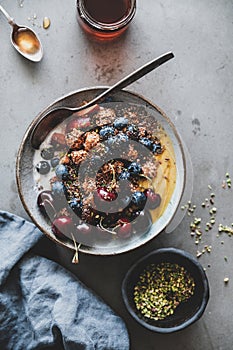Healthy breakfast with quinoa granola coconut yogurt bowl on table