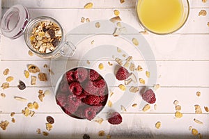 Healthy breakfast with raspberry cereals and orange juice photo
