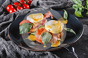 Healthy breakfast sandwiches. Bread toasts with Poached eggs or eggs Benedict, fresh vegetables, avocado, fillet salmon