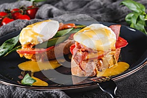 Healthy breakfast sandwiches. Bread toasts with Poached eggs or eggs Benedict, fresh vegetables, avocado, fillet salmon photo