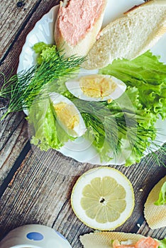Healthy breakfast, sandwiches coffee salad eggs on dark wooden background. Plate food green vegetarian