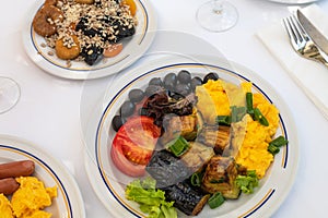 Healthy breakfast with scrambled eggs, vegetables and dried fruits