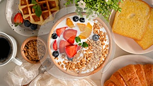 Healthy breakfast set with granola and fresh berries bowl