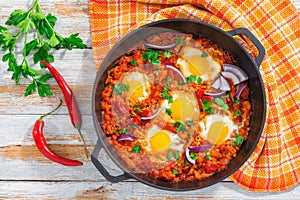 healthy breakfast shakshuka - fried eggs, tomato, pepper and spices