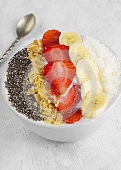 Healthy breakfast of smoothie with chia, coco, strawberry, nuts