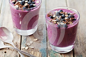 Healthy breakfast of smoothie, dessert, yogurt or milkshake with frozen berry and oats decorated grated chocolate